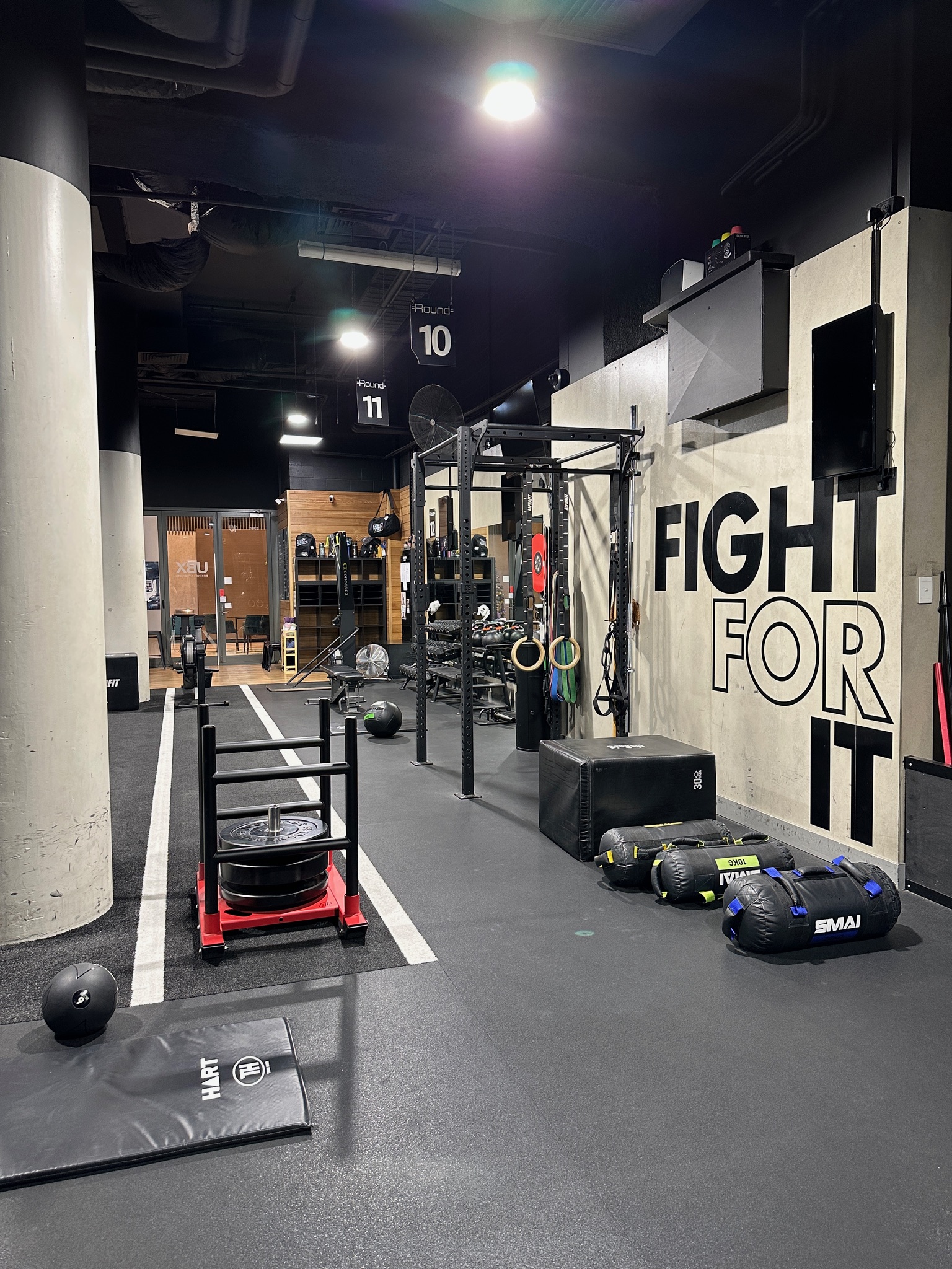 Open training floor with Fight For It wall branding