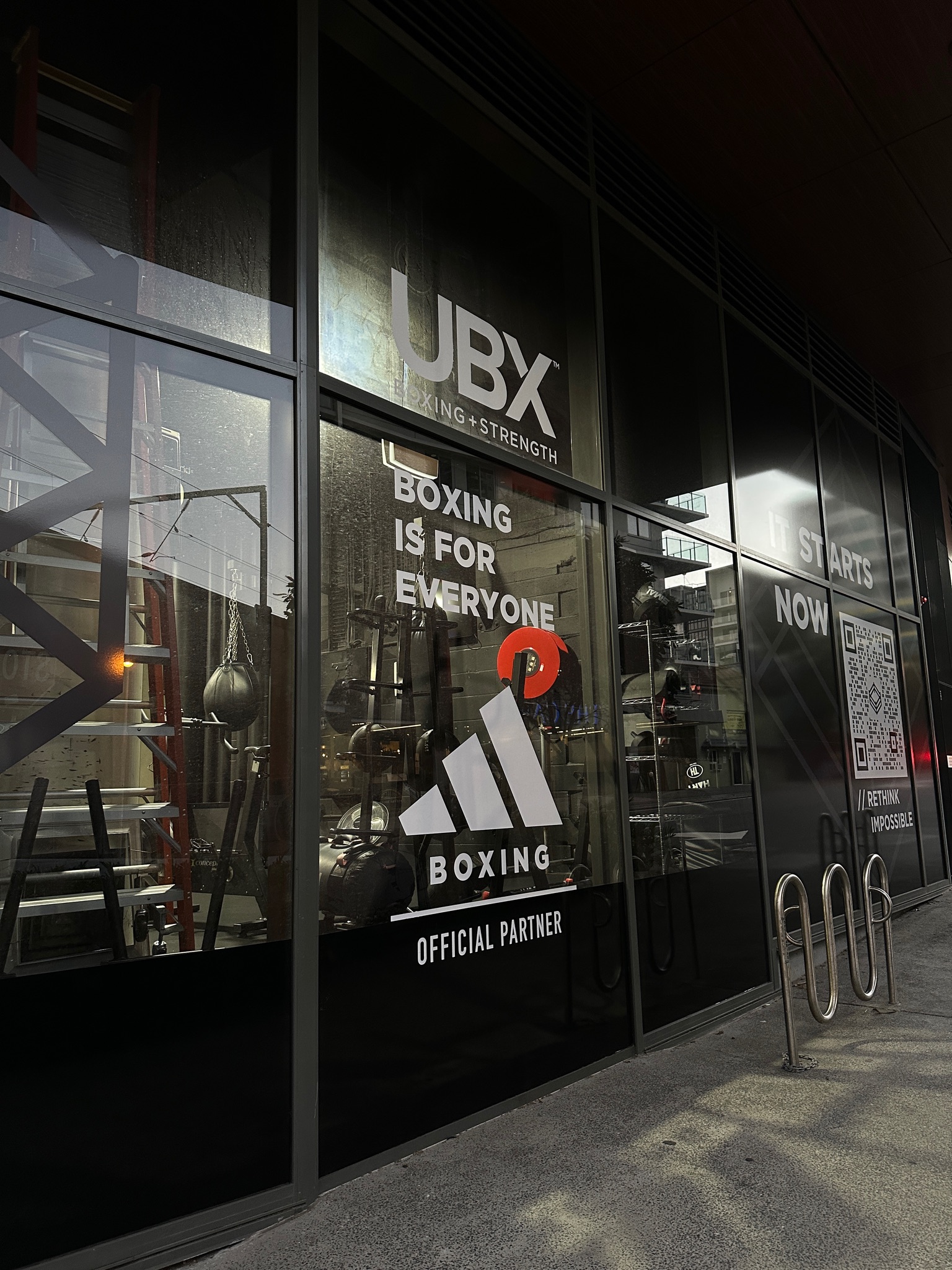 adidas Boxing official-partner window branding at dusk